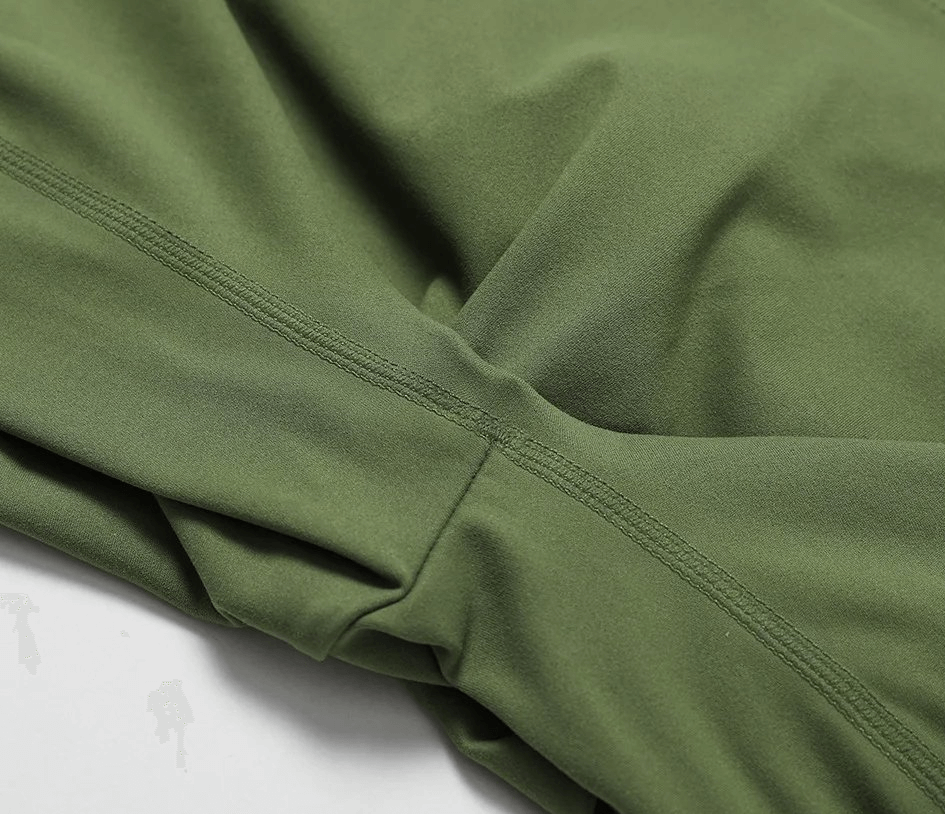 Close-up of green women's elastic performance yoga shorts, showcasing durable nylon and spandex blend for flexible active wear.